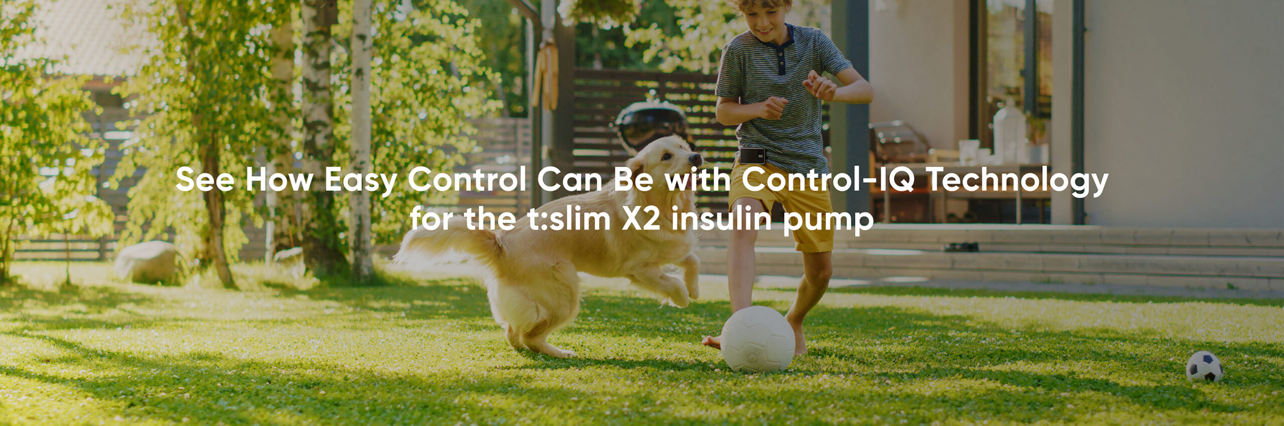 A kid living with diabetes wearing a Dexcom CGM, Dexcom G7 playing with his dog